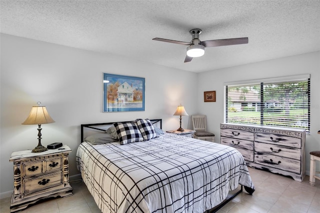 3362 Sandleheath Unit 12, Sarasota, FL 34235 - bedroom with light tile patterned flooring, a textured ceiling, and a ceiling fan