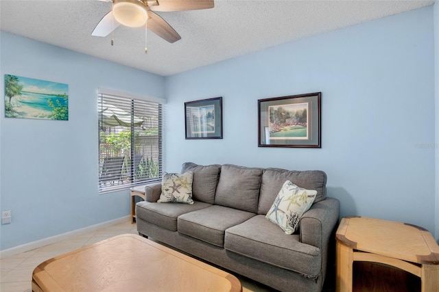 3362 Sandleheath Unit 12, Sarasota, FL 34235 - living area featuring a ceiling fan, a textured ceiling, and baseboards