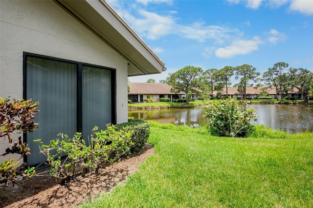 3362 Sandleheath Unit 12, Sarasota, FL 34235 - view of grassy yard with a water view and a residential view