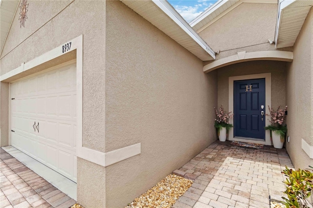 8937 Excelsior Loop, Venice, FL 34293 - doorway to property featuring stucco siding