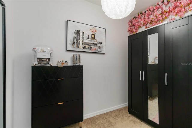 8937 Excelsior Loop, Venice, FL 34293 - entryway featuring light colored carpet, a chandelier, and baseboards