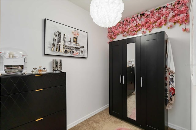 8937 Excelsior Loop, Venice, FL 34293 - bedroom featuring light carpet, a chandelier, and baseboards