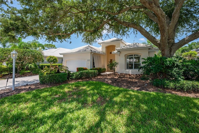 7952 Hampton Ct, University Park, FL 34201 - view of front facade with a garage, stucco siding, and a front yard