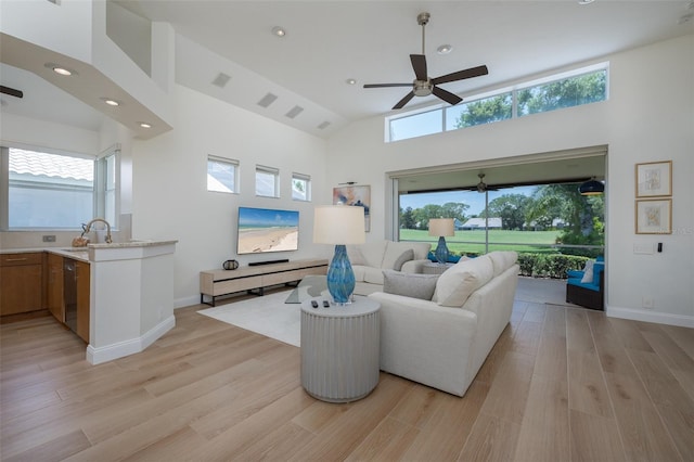 7952 Hampton Ct, University Park, FL 34201 - living area with a ceiling fan, light wood-style flooring, recessed lighting, high vaulted ceiling, and baseboards