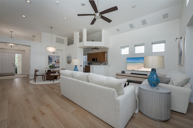 7952 Hampton Ct, University Park, FL 34201 - living room featuring ceiling fan, high vaulted ceiling, healthy amount of natural light, light wood finished floors, and recessed lighting