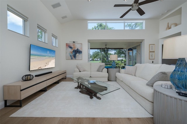 7952 Hampton Ct, University Park, FL 34201 - living room with ceiling fan, plenty of natural light, high vaulted ceiling, wood finished floors, and baseboards