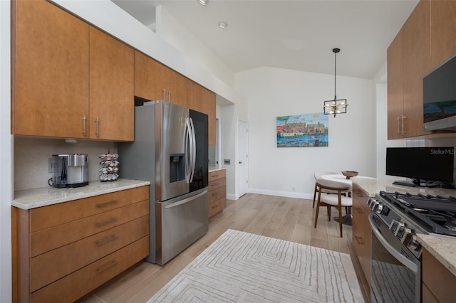 7952 Hampton Ct, University Park, FL 34201 - kitchen with appliances with stainless steel finishes, vaulted ceiling, light wood-style floors, brown cabinets, and baseboards