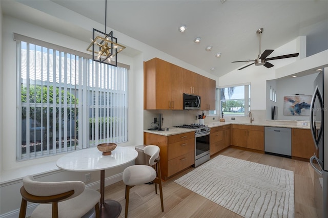 7952 Hampton Ct, University Park, FL 34201 - kitchen featuring stainless steel appliances, brown cabinets, light wood-style floors, a chandelier, and recessed lighting