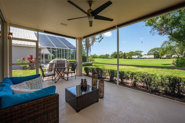 7952 Hampton Ct, University Park, FL 34201 - sunroom / solarium featuring ceiling fan, an outdoor living space, and healthy amount of natural light