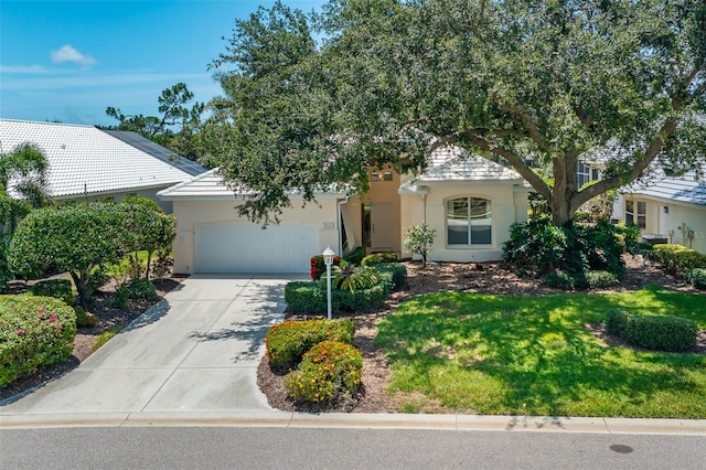 7952 Hampton Ct, University Park, FL 34201 - obstructed view of property featuring stucco siding, driveway, and a garage