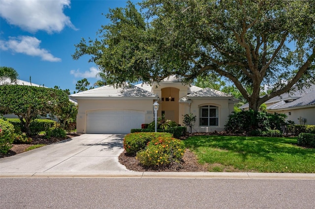 7952 Hampton Ct, University Park, FL 34201 - mediterranean / spanish-style home with an attached garage, stucco siding, driveway, and a front yard