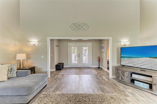 3903 Bayside Dr, Bradenton, FL 34210 - living area with french doors, wood finished floors, baseboards, and a towering ceiling