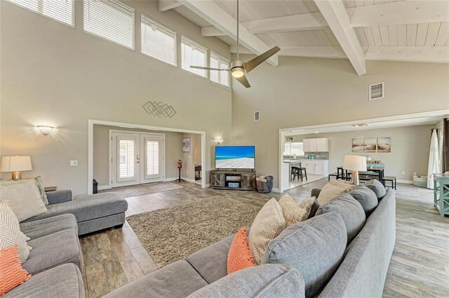 3903 Bayside Dr, Bradenton, FL 34210 - living room featuring high vaulted ceiling, ceiling fan, beam ceiling, light wood finished floors, and french doors