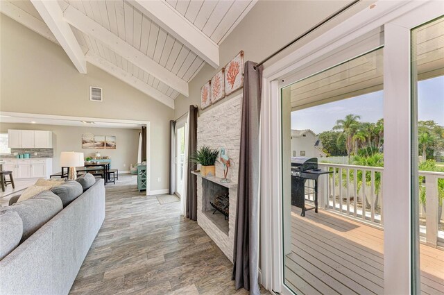 3903 Bayside Dr, Bradenton, FL 34210 - living area featuring light wood-type flooring, wood ceiling with exposed beams, baseboards, high vaulted ceiling, and a fireplace