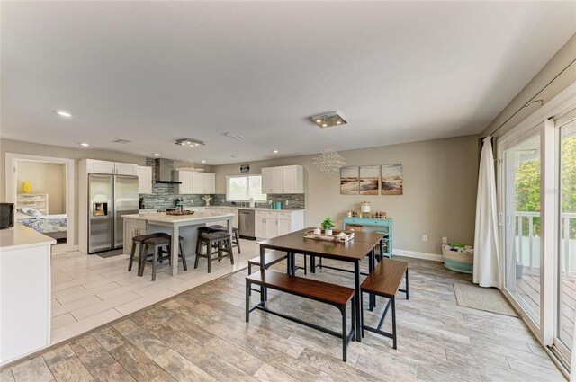 3903 Bayside Dr, Bradenton, FL 34210 - dining area with healthy amount of natural light, recessed lighting, light wood-style floors, and baseboards