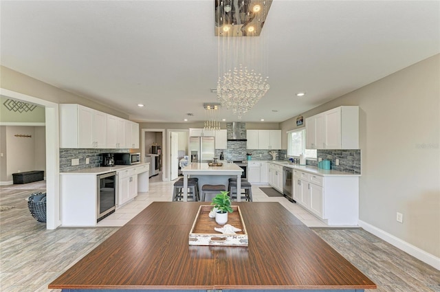 3903 Bayside Dr, Bradenton, FL 34210 - dining area featuring a chandelier, beverage cooler, baseboards, light wood-type flooring, and recessed lighting