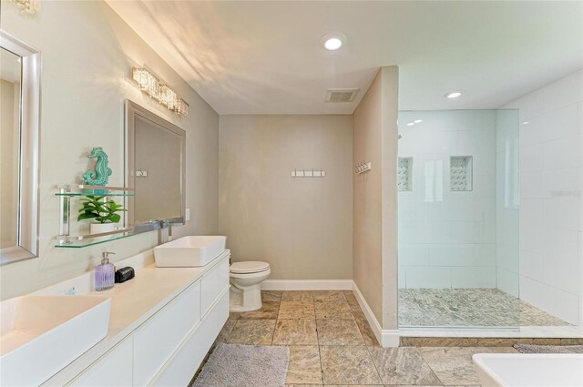 3903 Bayside Dr, Bradenton, FL 34210 - bathroom with double vanity, walk in shower, toilet, baseboards, and recessed lighting