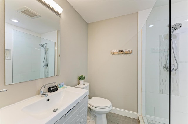 3903 Bayside Dr, Bradenton, FL 34210 - bathroom with tiled shower, vanity, toilet, tile patterned flooring, and baseboards