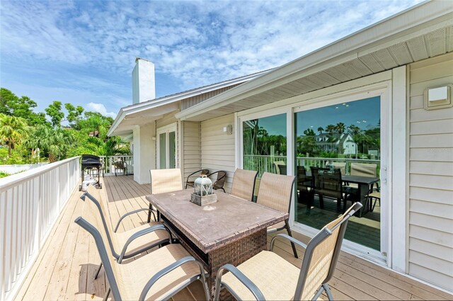 3903 Bayside Dr, Bradenton, FL 34210 - wooden terrace featuring outdoor dining area