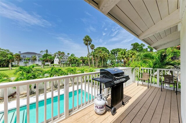 3903 Bayside Dr, Bradenton, FL 34210 - deck with grilling area and an outdoor pool