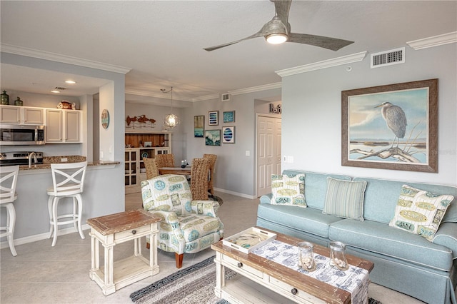 7005 River Hammock Dr Unit 303, Bradenton, FL 34212 - living room featuring crown molding, a ceiling fan, baseboards, and light tile patterned flooring