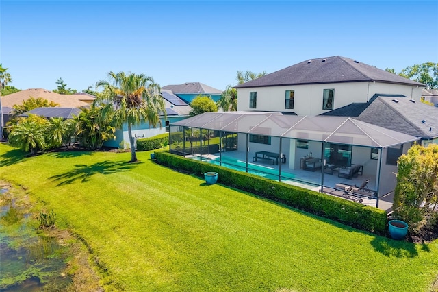 826 Honeyflower Loop, Bradenton, FL 34212 - rear view of property featuring a patio area, a yard, stucco siding, a shingled roof, and a lanai