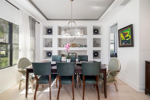 826 Honeyflower Loop, Bradenton, FL 34212 - dining area featuring a chandelier, healthy amount of natural light, built in shelves, and a tray ceiling