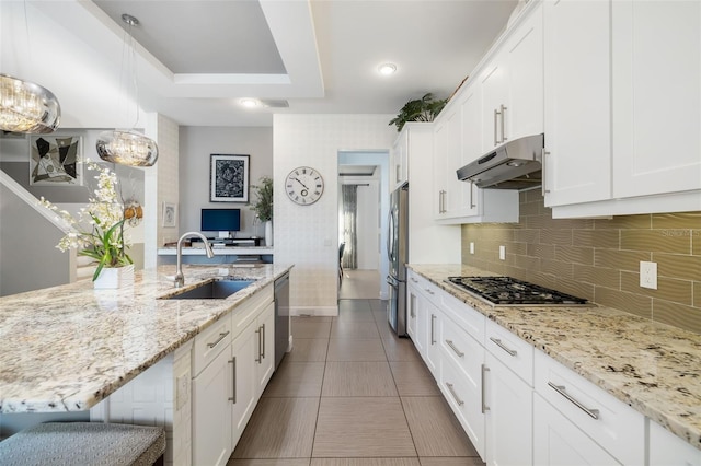826 Honeyflower Loop, Bradenton, FL 34212 - kitchen featuring under cabinet range hood, stainless steel appliances, white cabinetry, and backsplash