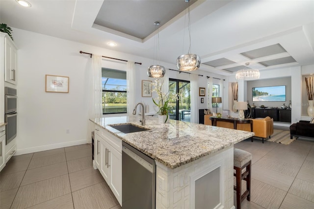826 Honeyflower Loop, Bradenton, FL 34212 - kitchen featuring stainless steel appliances, open floor plan, coffered ceiling, a center island with sink, and a breakfast bar area
