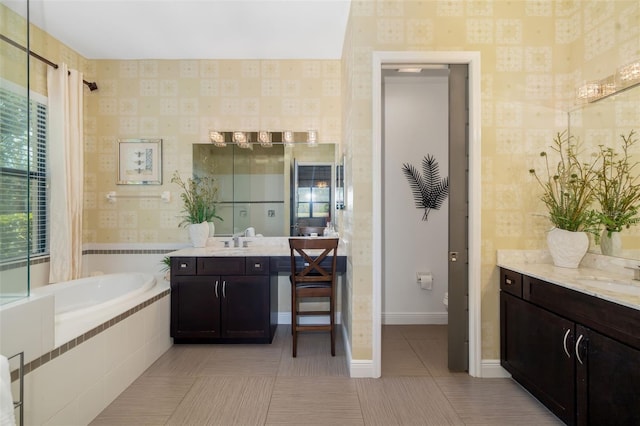 826 Honeyflower Loop, Bradenton, FL 34212 - bathroom featuring wallpapered walls, a garden tub, two vanities, and tile patterned floors