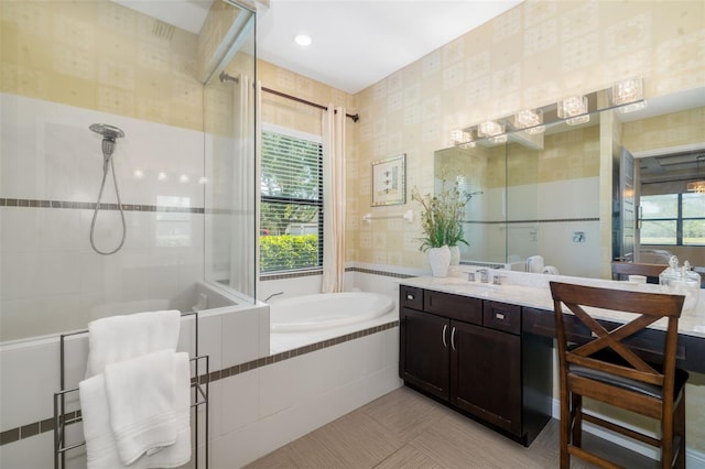 826 Honeyflower Loop, Bradenton, FL 34212 - bathroom with a garden tub, vanity, a tile shower, tile walls, and tile patterned flooring