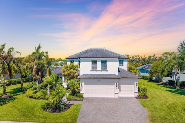 826 Honeyflower Loop, Bradenton, FL 34212 - view of front of property with stucco siding, decorative driveway, a garage, and a front lawn