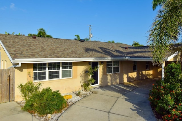 6731 Washington Pl, Bradenton, FL 34207 - ranch-style house featuring stucco siding, a carport, roof with shingles, and concrete driveway