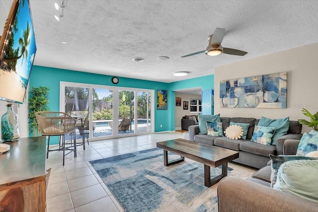 6731 Washington Pl, Bradenton, FL 34207 - living area with tile patterned flooring, a ceiling fan, and a textured ceiling