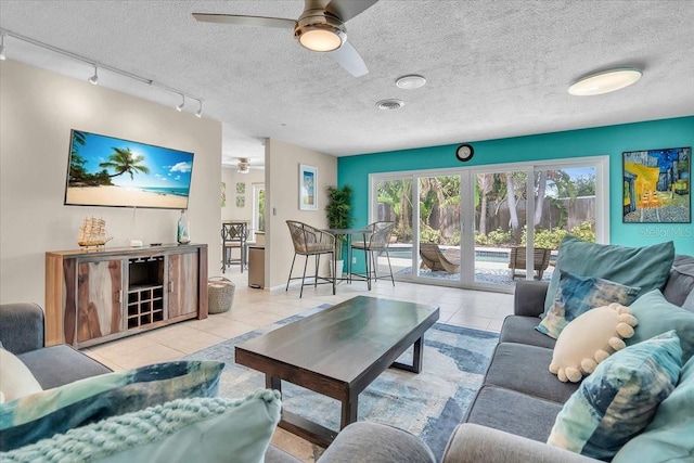6731 Washington Pl, Bradenton, FL 34207 - tiled living room with a ceiling fan, track lighting, and a textured ceiling