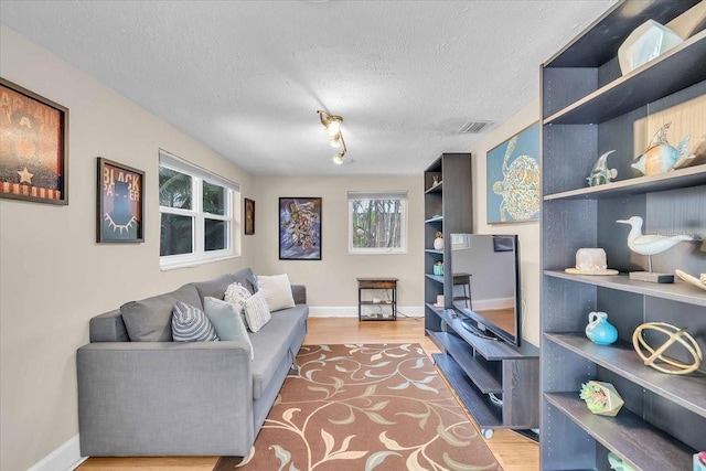 6731 Washington Pl, Bradenton, FL 34207 - living area featuring wood finished floors, baseboards, and a textured ceiling
