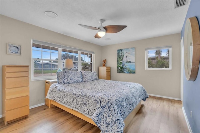 6731 Washington Pl, Bradenton, FL 34207 - bedroom featuring wood finished floors, baseboards, a textured ceiling, and ceiling fan