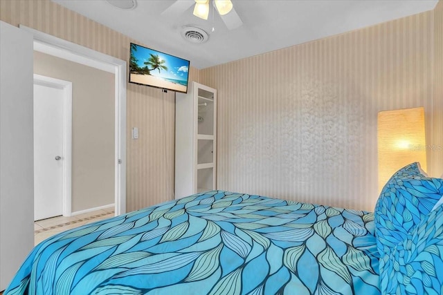6731 Washington Pl, Bradenton, FL 34207 - bedroom with wallpapered walls, a ceiling fan, baseboards, and a closet