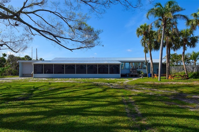 6731 Washington Pl, Bradenton, FL 34207 - back of property with a sunroom and a lawn