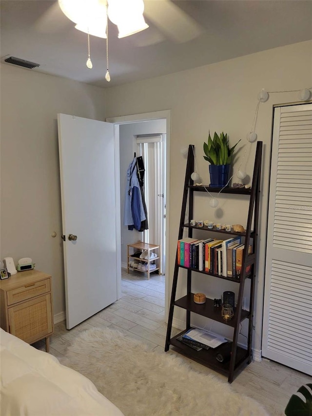 4835 Winslow Beacon Unit 46, Sarasota, FL 34235 - bedroom featuring light wood-style flooring and a ceiling fan