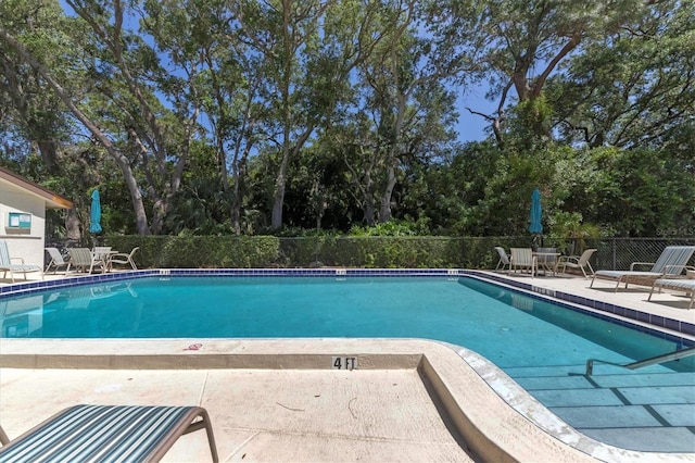 4835 Winslow Beacon Unit 46, Sarasota, FL 34235 - community pool with a patio and view of scattered trees