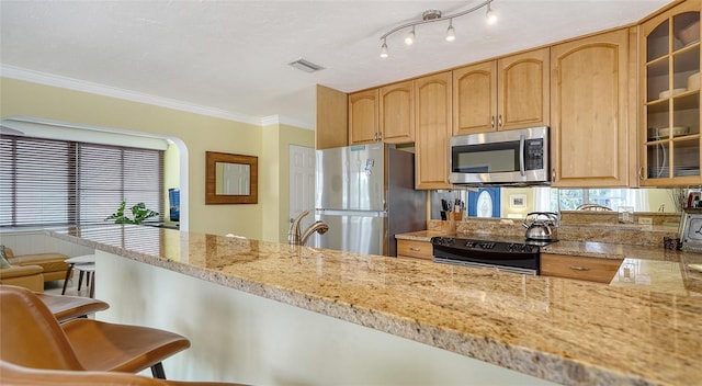 1116 S Moonmist Ct Unit M12, Sarasota, FL 34242 - kitchen featuring stainless steel appliances, glass insert cabinets, a kitchen breakfast bar, light stone counters, and crown molding