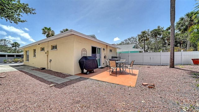 1116 S Moonmist Ct Unit M12, Sarasota, FL 34242 - rear view of house with stucco siding and a patio area
