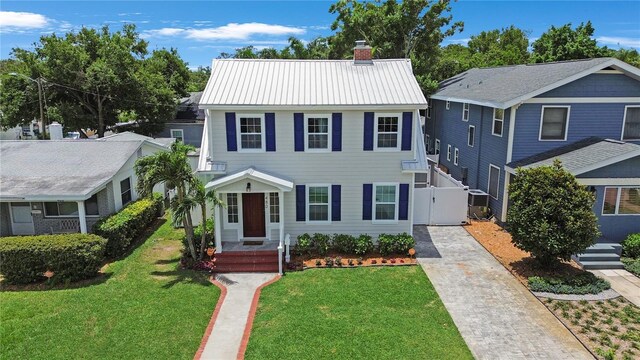 480 28th Ave N, Saint Petersburg, FL 33704 - view of front of home featuring a chimney, driveway, a gate, and metal roof