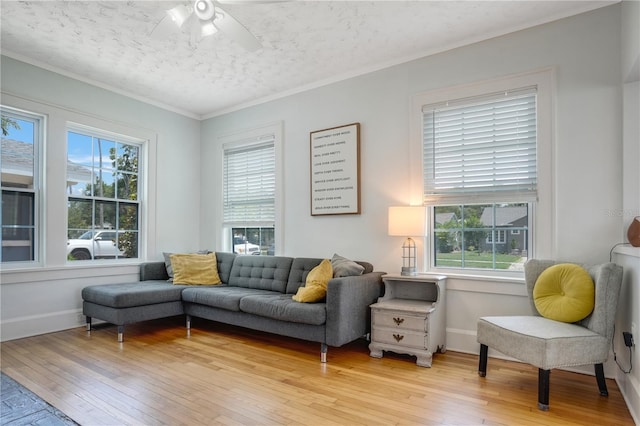 480 28th Ave N, Saint Petersburg, FL 33704 - living area featuring light wood-type flooring, a ceiling fan, a textured ceiling, ornamental molding, and baseboards