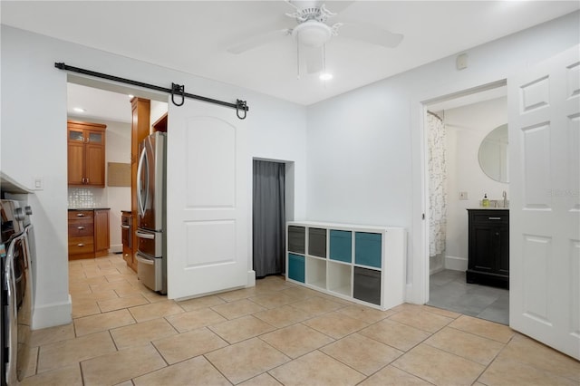 480 28th Ave N, Saint Petersburg, FL 33704 - unfurnished room with a barn door, light tile patterned flooring, a ceiling fan, a sink, and recessed lighting