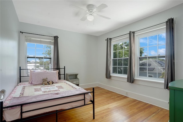 480 28th Ave N, Saint Petersburg, FL 33704 - bedroom with light wood finished floors, multiple windows, baseboards, and ceiling fan