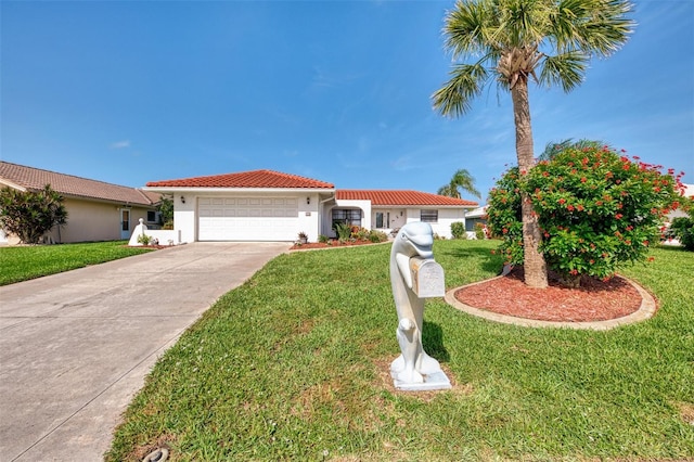 74 Windsor Dr, Englewood, FL 34223 - mediterranean / spanish house with a garage, a front yard, concrete driveway, stucco siding, and a tiled roof