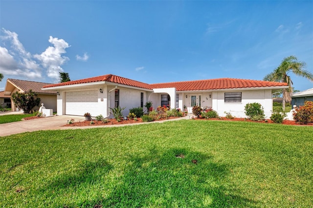 74 Windsor Dr, Englewood, FL 34223 - mediterranean / spanish-style house with stucco siding, a garage, a front yard, and concrete driveway