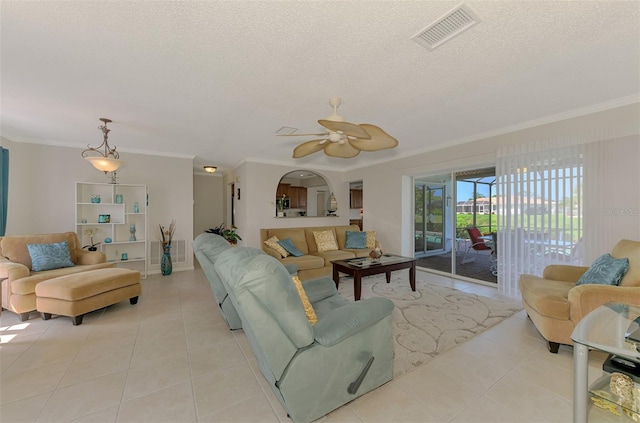 74 Windsor Dr, Englewood, FL 34223 - living area featuring light tile patterned floors, ornamental molding, a textured ceiling, and a ceiling fan